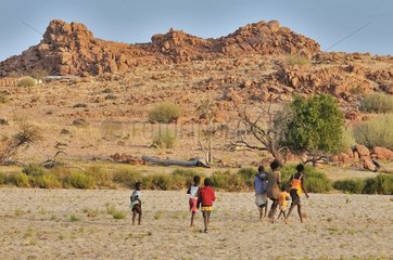 Hereros children and Brandberg Mountain in Namibia