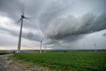 Storm front and wind turbines in the countryside - France