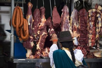 Meat hanging on a market stall Otavalo Ecuador