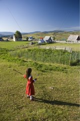 Little girl playing with a stick in a pre Durmitor NP