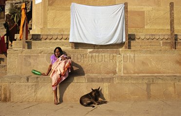 Woman and Dog sitting on ghats India