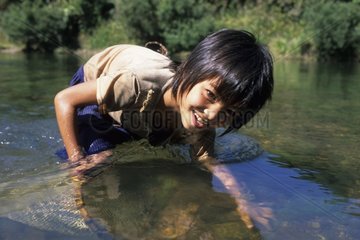 Akha young girl fishing with the net District of Muang Sing Laos
