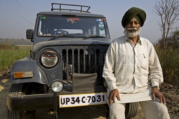 Old Man of the Sikh community in front of his vehicle India