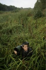 Naturalist photographer observing in a swamp