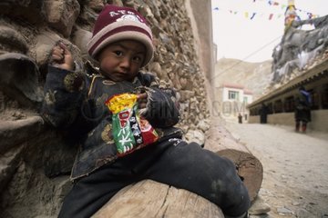 Tibetan child in front of a Buddhist temple Yushu China
