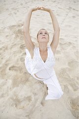 Woman praticing yoga on a beach in Martinique Island