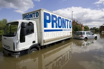 Vehicles partly submerged on a flooded road UK