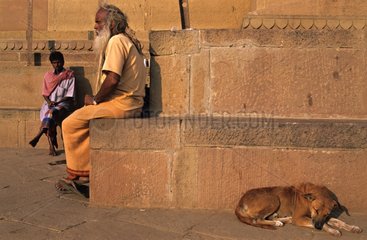 Men and Dog on ghats beside the Ganges India