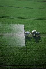 Spraying herbicide on cereal field in autumn