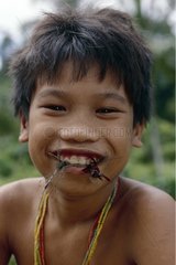 Mentawai child eating a dragonfly Siberut Sumatra