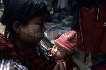 Young mother carrying her baby Rangoon Myanmar
