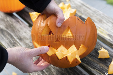 Little girls making a Halloween pumpkin
