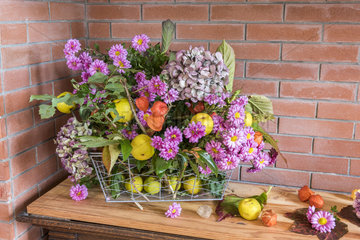 Autumn bouquet composed of chrysanthemums  hydrangea  physalis and quinces
