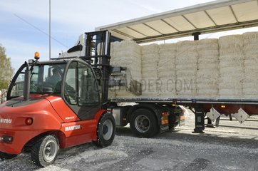 Unloading a truck of newspapers in a paper mill France