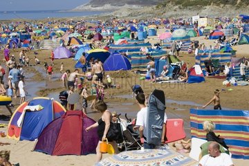 Crowd of holidaymakers on a beach in summer England