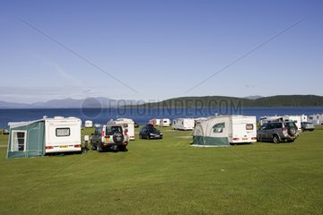 Cars and caravans parked on the coast Scotland UK