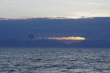 Sun behind clouds Frederick Sound Alaska