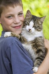 Portrait of a boy with a cat