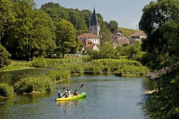 Childrens in canoe on the Doubs and abbey Haut Doubs France
