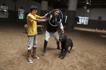 Child making a trust exercise with a dog - Argentina