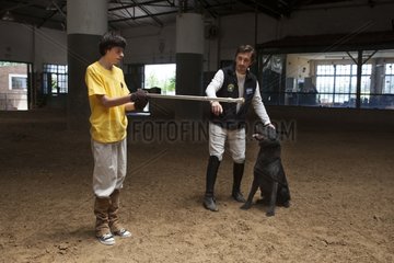 Child making a trust exercise with a dog - Argentina
