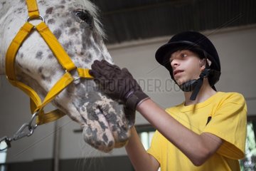 Child and horse in a horse therapy center - Argentina