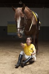 Woman making a exercise in trust with a horse