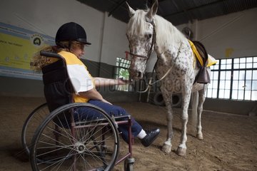 Paraplegic woman and horse in a horse therapy center