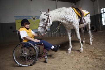 Paraplegic woman and horse in a horse therapy center