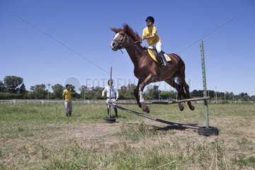 Woman making a jump of horse therapy center