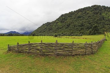 Braided wooden fence separating fields - Chilean Patagonia