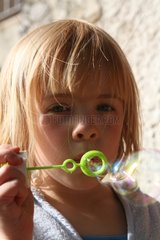 Portrait a girl making bubbles