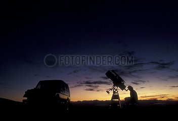 Astronomer observing the sky in morning twilight Provence