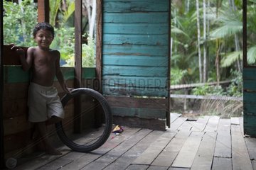 Child playing with a tire - Amapa Brazil Amazon