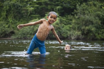 Boy playing in the water - Amazon Amapa Brazil