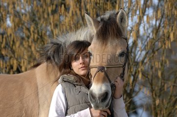 Young woman and Pony Fjord in winter - France