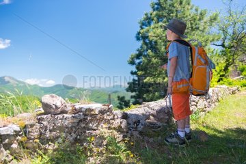 Boy with a hat in front of a landscape Cevennes - France