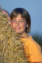 Portrait of a child near on a straw stack