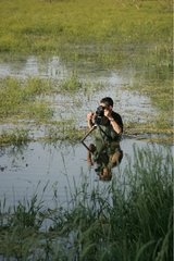 Naturalist photographer shooting in a swamp