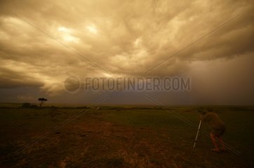 Photographer and sky storm Masai Mara Reserve Kenya
