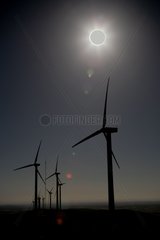 Solar eclipse over a windmill farm Spain
