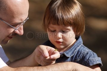 Man making an insect to discover his daughter in the forest