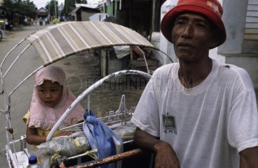 Young girl buying a drink after school in Cirebon Indonesia