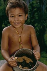 Mentawai child and larvae of coleopters Siberut Sumatra