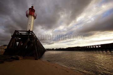 Headlight and pier of Trouville under a threatening sky