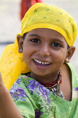 Young girl aged 5 in costume on road to Jodhpur in Rajasthan India