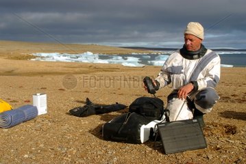 Man in the Arctic with a satellite phone