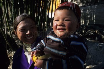 Portrait of a Naxi child and his mother Yunnan China