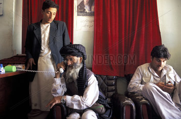 Kabul  a man making a phonecall in a phone shop