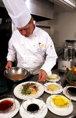 Chef preparing fine meal in fancy restaurant